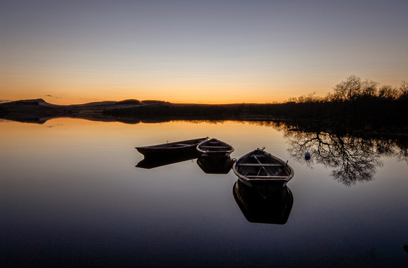 Crag Lough and rowing boats at sunset
